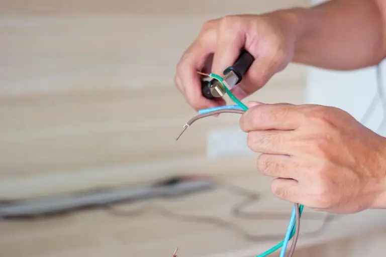 Electrician stripping and preparing cabling during a rewire